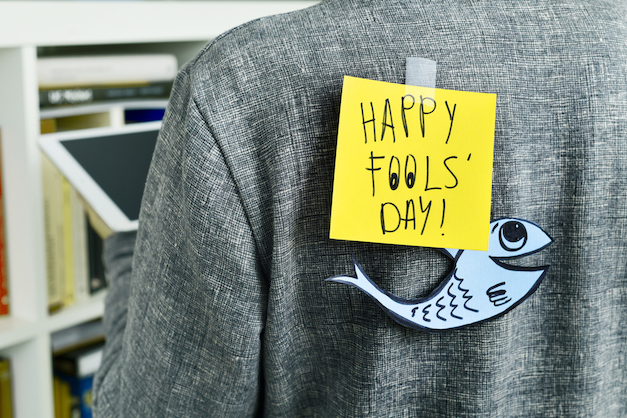 man with text happy fools day attached to his back